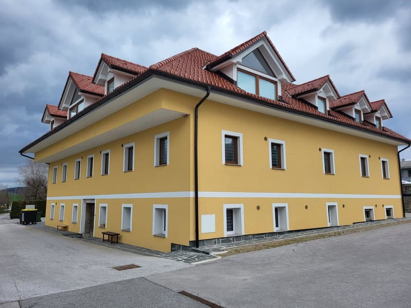The Stara Pošta building: ochre facade, terracotta roof and parking next to the house